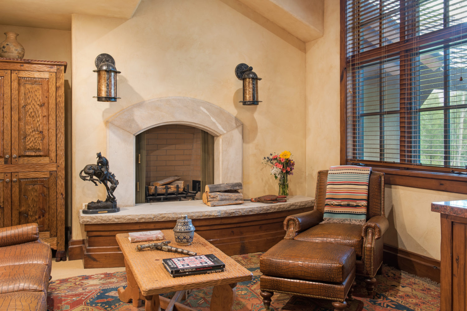 main_house_master_sitting_room A sitting room with leather chairs and a fireplace