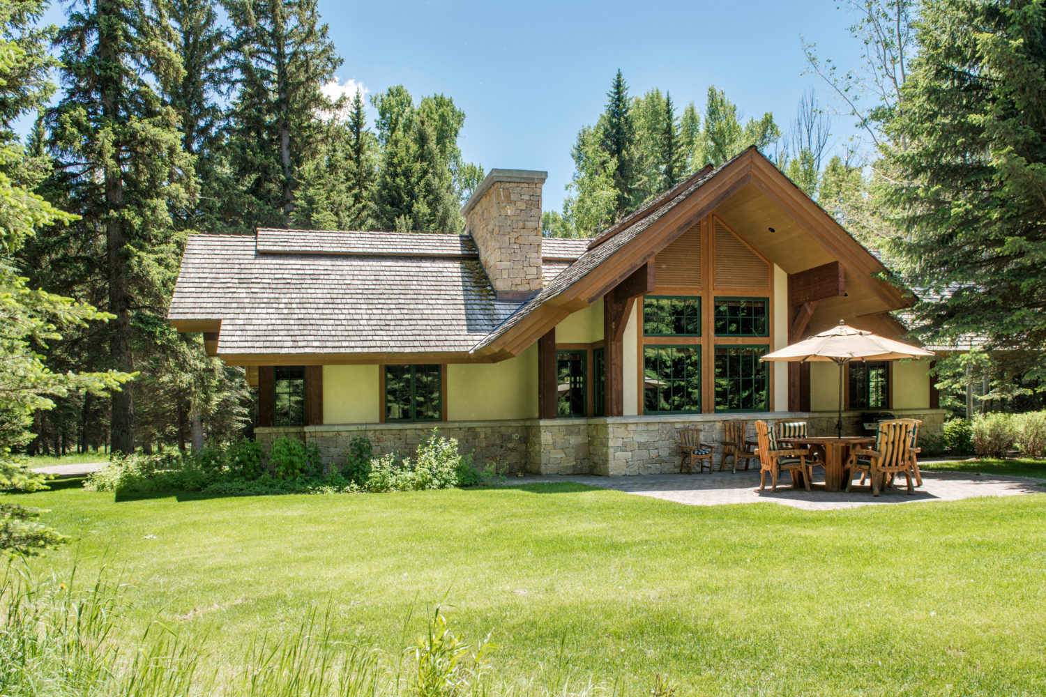 woods_house_outside A western lodge style home in front of a grassy lawn