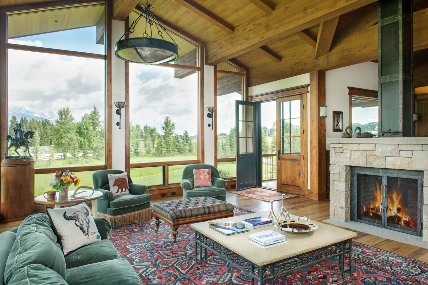 gate_house_living_room A living room with floor to ceiling windows and a fireplace