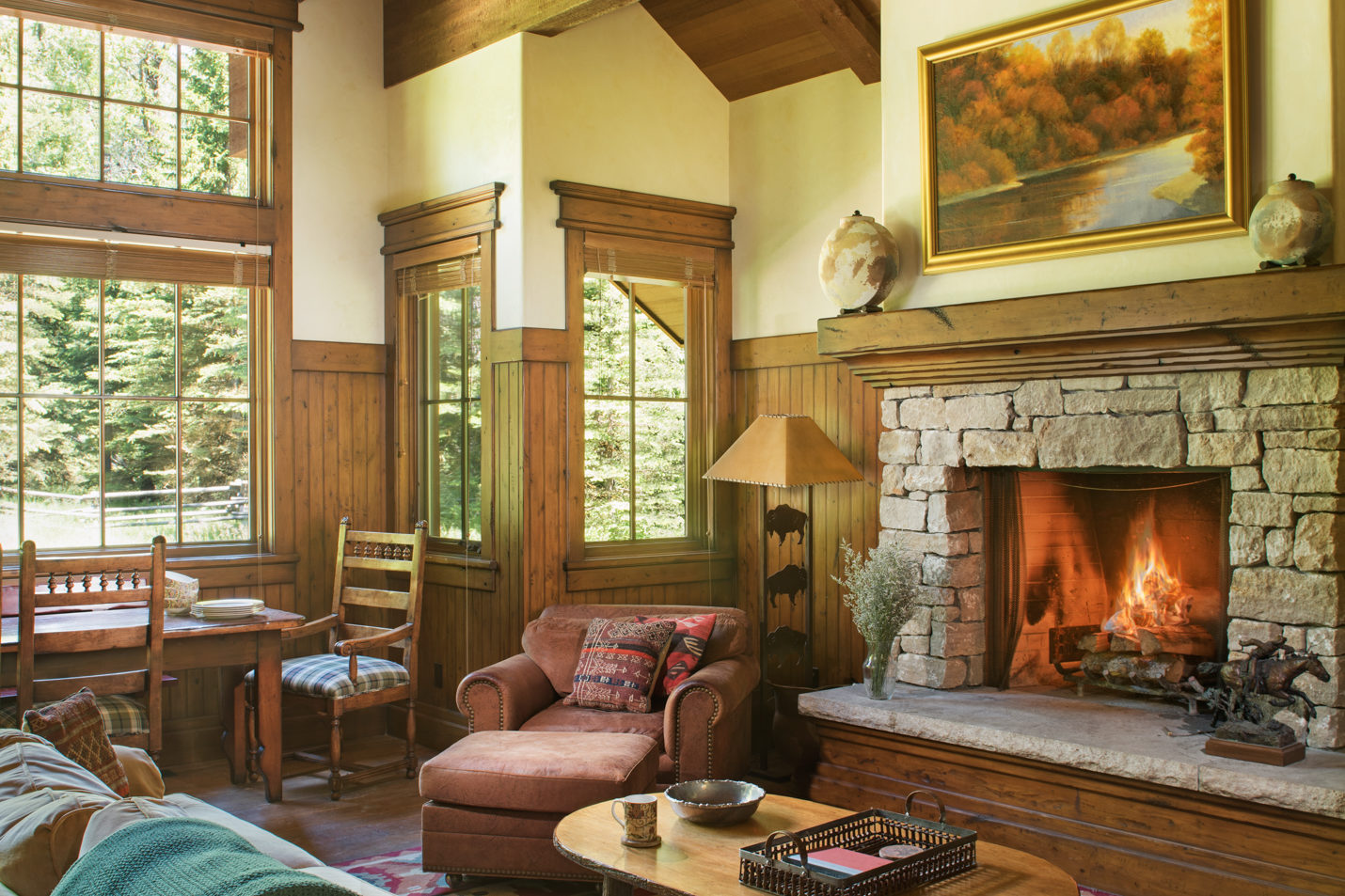 woods_house_living_room A large decorative living room and dining area with a lit fireplace