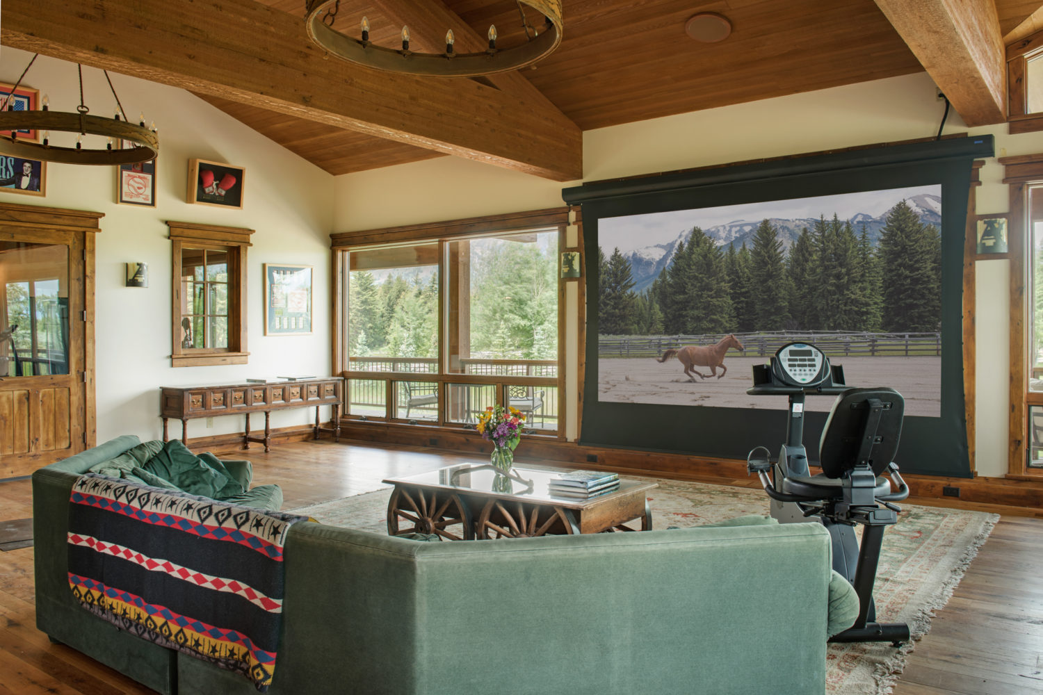 teewinot_room_projector An open room with a big couch and large projector screen