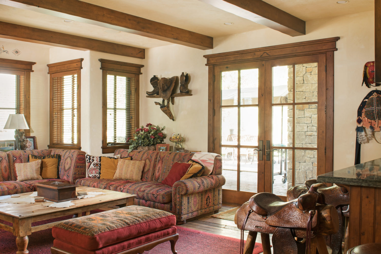 main_house_family_room A cozy sitting room with a large couch and saddle barstools