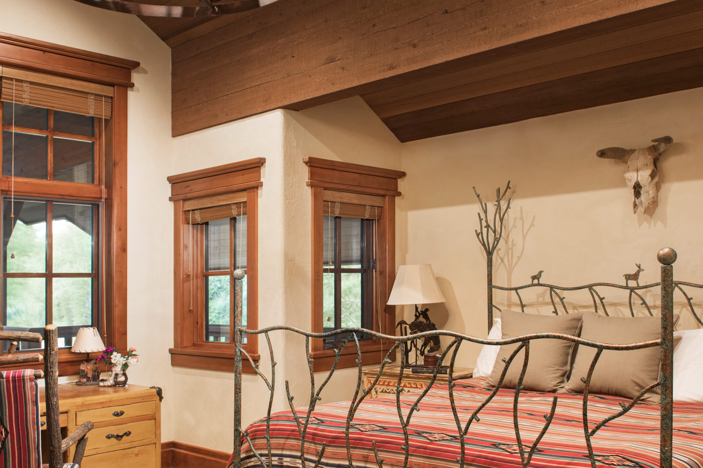 main_house_bedroom_1 A spacious bedroom with a king-sized bed and large desk