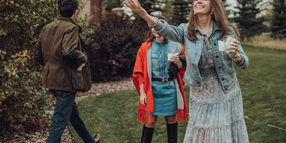 woman_playing_lawn_game A woman holding a drink smiles while playing a lawn game