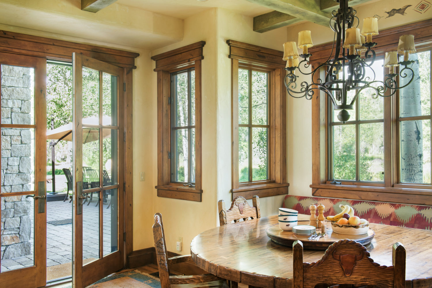 main_house_kitchen_dining A semicircle wood dining table and chairs with windows