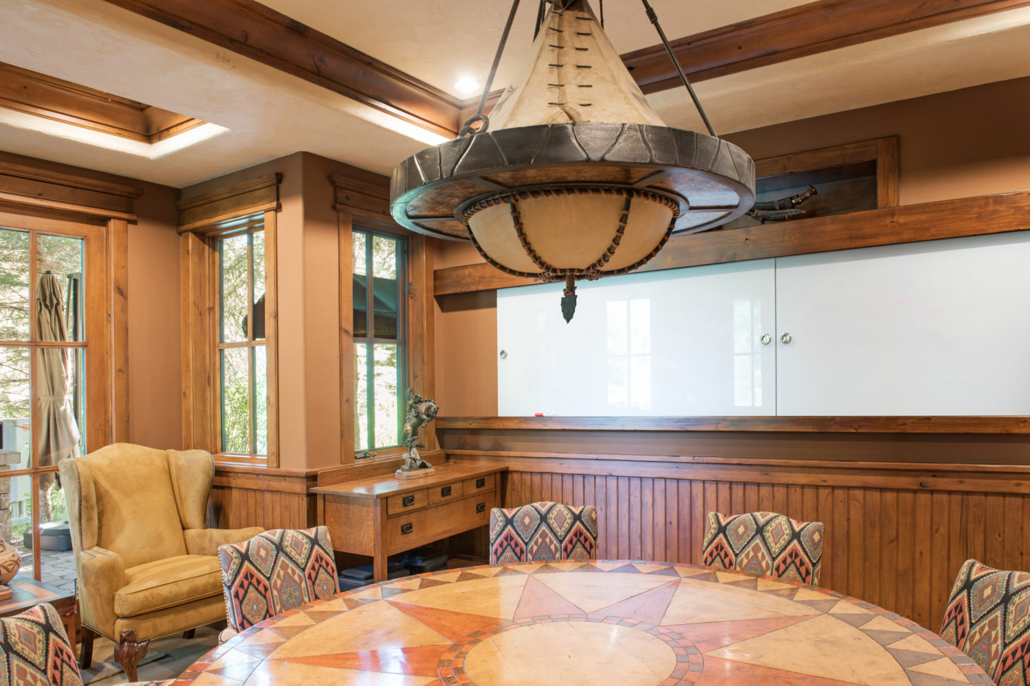 main_house_conference_room A large conference room with a circular table and a whiteboard